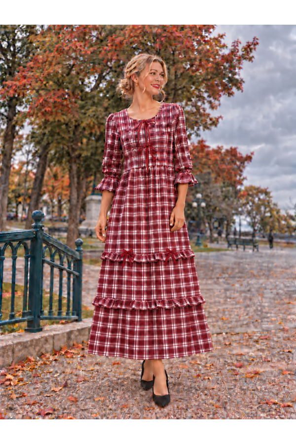 MD13277A / Celeste Design<br/>Maxi plaid dress with 3/4 sleeves with ruffle cuffs, and delicate bow accents down the bodice.